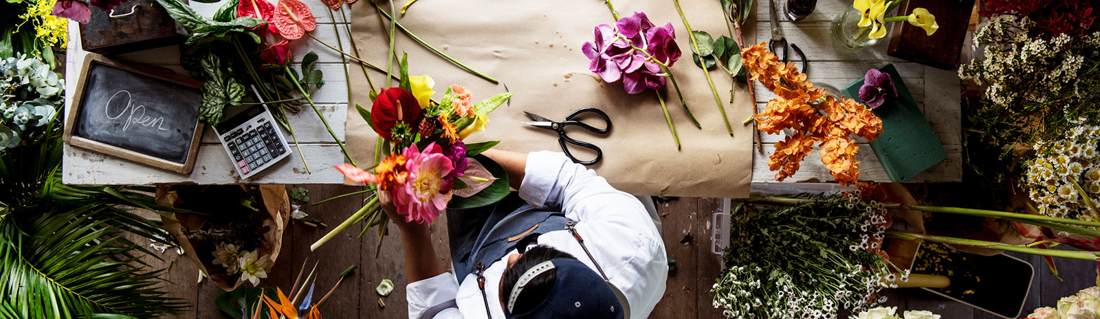 top-down view of a worker cutting flowers